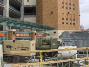 Rental chiller and diesel generator set up beside a building